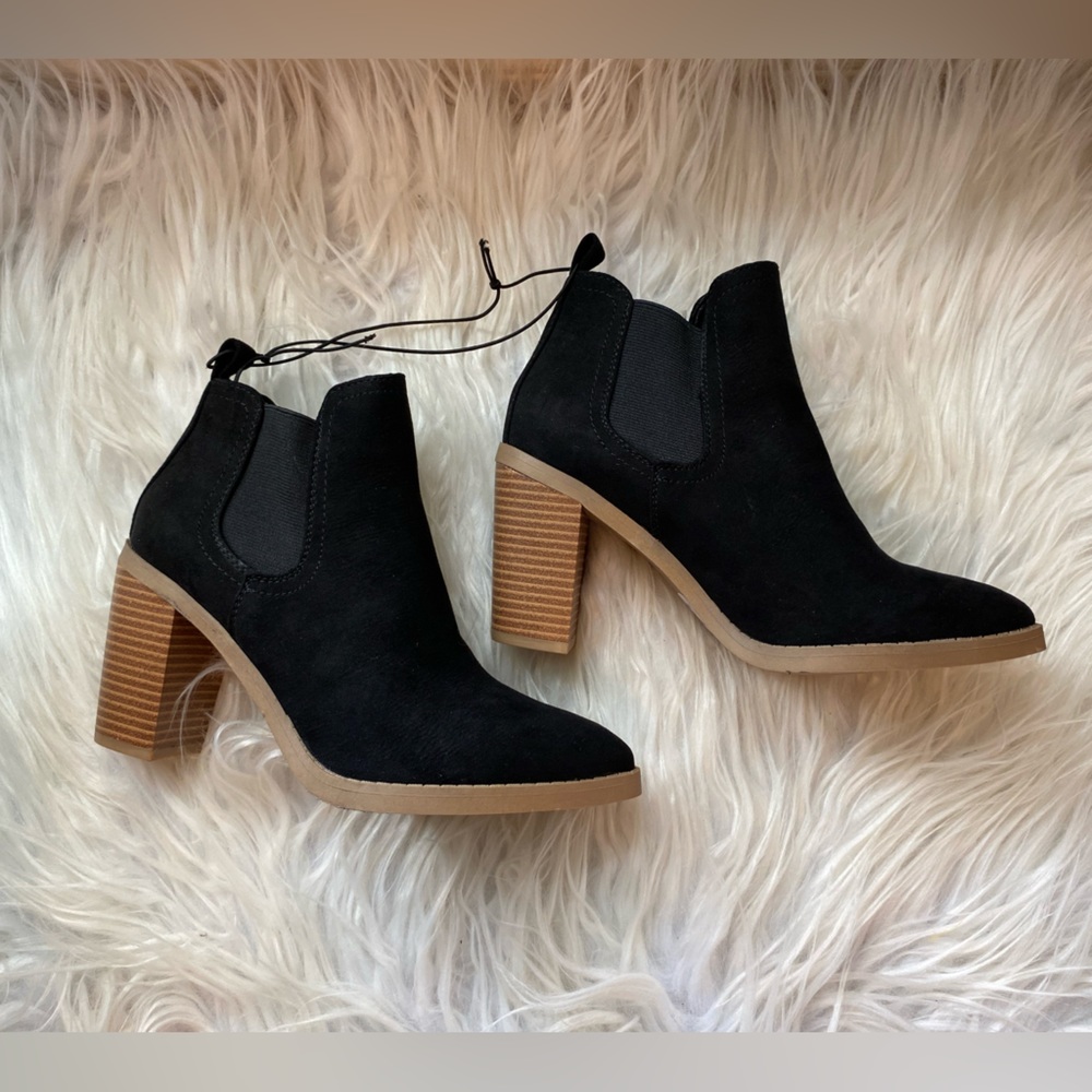Black booties with a small tan heel